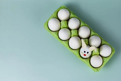 Happy Easter. Easter eggs. Chicken white eggs on green background. Stock Photos