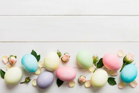 Happy Easter. Easter eggs on colored table with yellow roses. Natural dyed .. Stock Photos
