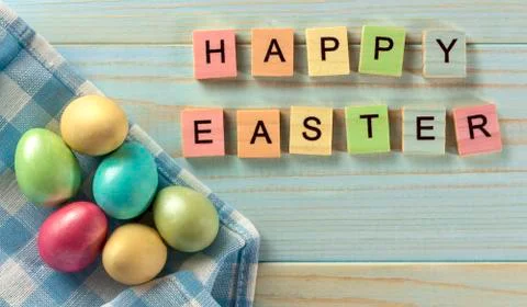 Happy Easter, Easter eggs on a wooden blue background, rustic style. Wooden c Stock Photos