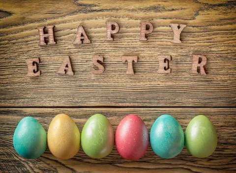 Happy Easter, Easter eggs on a wooden background, rustic style. Wooden letter Stock Photos