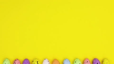 Happy Easter eggs appear and disappear on bottom of yellow theme. Stop motion Stock Footage 149266328