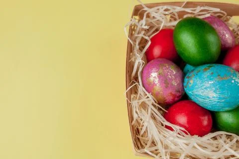 Happy Easter eggs yellow background. Golden shine decorated eggs in basket, f Foto stock