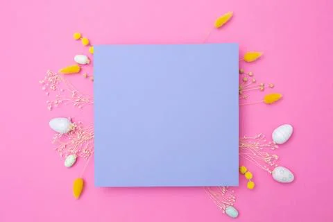 Happy Easter. Empty viola paper with arrangement of Easter eggs and spring dried Stock Photos