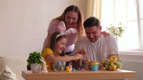 Happy easter. Family painted eggs at home. Father, mother and daughter wearing b Stock Footage 149526184