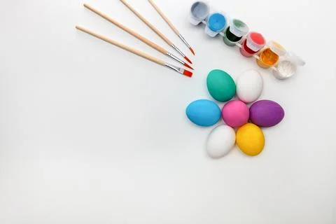 Happy Easter flat composition. Easter eggs with brushes and watercolors Stock Photos