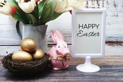 Happy Easter with flower, rabbit and easter eggs decoration on wooden backgro Stock Photos