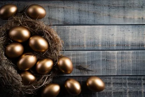 Happy easter! golden of Easter eggs in nest and Feather on wooden background. Stock Photos