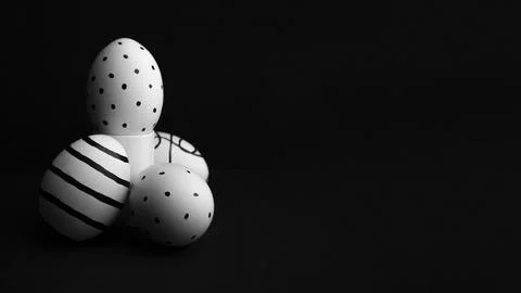 Happy Easter greeting card. Eggs with black dotted pattern on stand Stock Photos