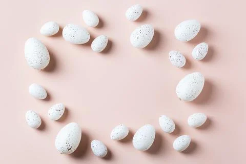 Happy Easter greeting card with eggs on pink background Stock Photos