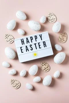 Happy Easter greeting card with eggs on pink background Stock Photos