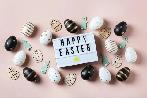 Happy Easter greeting card with eggs on pink background Stock Photos