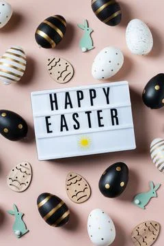 Happy Easter greeting card with eggs on pink background Stock Photos
