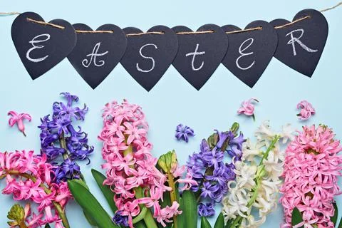 Happy easter greeting card. Multicolored hyacinth flowers and garland with Stock Photos