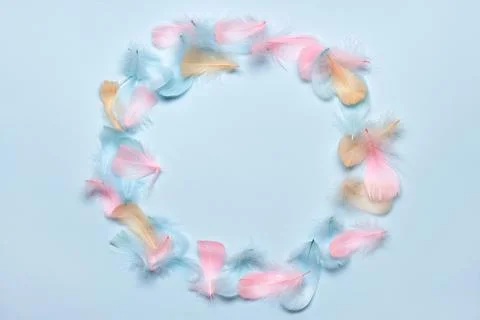 Happy easter greeting card template. Round frame made of colorful feathers on Stock Photos