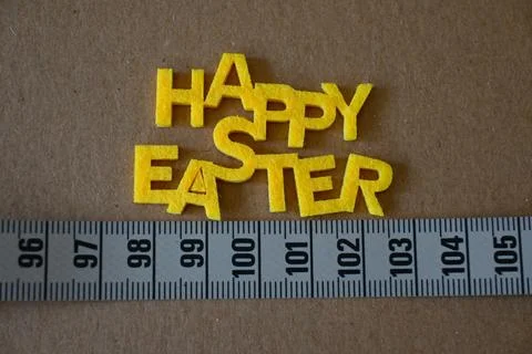 Happy Easter greeting with measuring tape Stock Photos