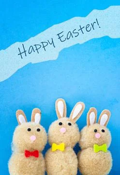 Happy Easter greeting with three Easter bunnies Stock Photos