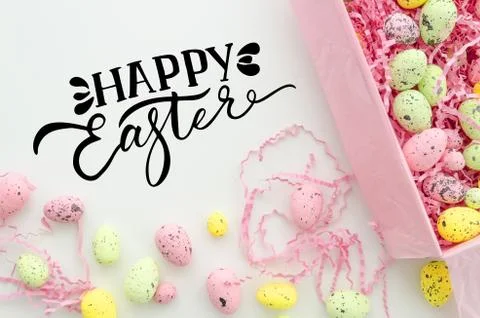 Happy easter hand lettering greeting card design.Colorful Easter eggs in a box Stock Photos