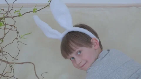 Happy Easter. A happy, funny boy in rabbit ears on his head  Stock Footage 149755813