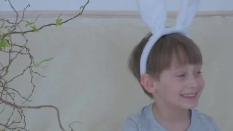Happy Easter. A happy, funny boy in rabbit ears on his head  Stock Footage 149755818