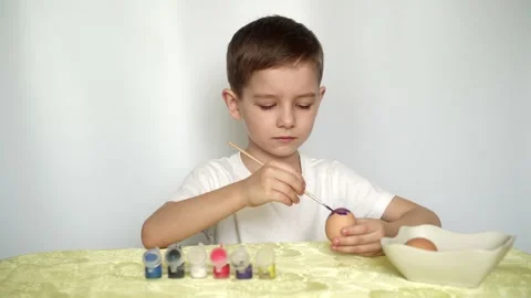 Happy Easter Holiday. Beautiful Caucasian kid boy paint and decorate eggs. Stock Footage 151007141