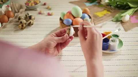 Happy Easter holiday. Coloring eggs top view. Woman preparing for Easter Stock Footage 171733713