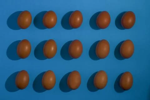 Happy Easter Holiday eggs in a pattern on blue background Stock Photos