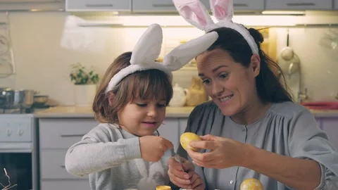 Happy Easter Holiday. Emotional and funny mother and son paint and decorate eggs Stock Footage 147739237