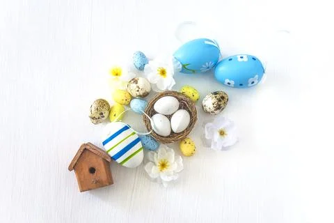 Happy easter holidays concept; Easter eggs, birdnest with eggs and flowers .. Stock Photos