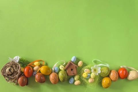 Happy easter holidays concept; Frame of easter eggs on green background, co.. Stock Photos