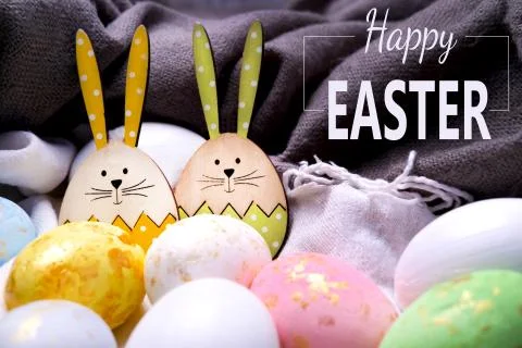 Happy easter. The inscription on the greeting Easter card with eggs, hares on Stock Photos