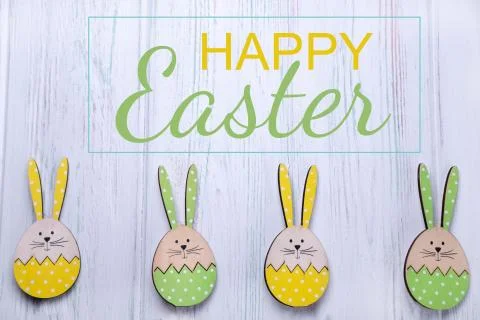 Happy easter. The inscription on the greeting Easter card with eggs, hares on Stock Photos