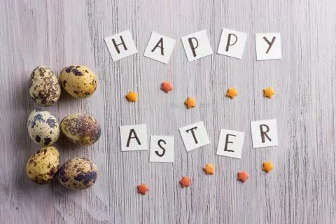 Happy Easter letters and easter eggs on the wooden table Stock Photos
