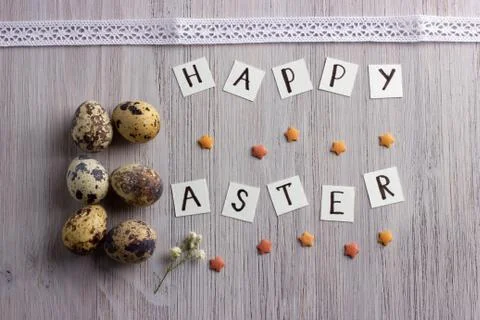 Happy Easter letters and easter eggs on the wooden table Stock Photos