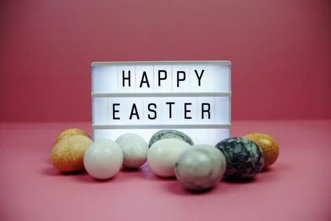 Happy Easter light box with easter element decoration on pink background Stock Photos