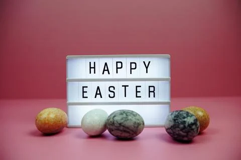 Happy Easter light box with easter element decoration on pink background Stock Photos