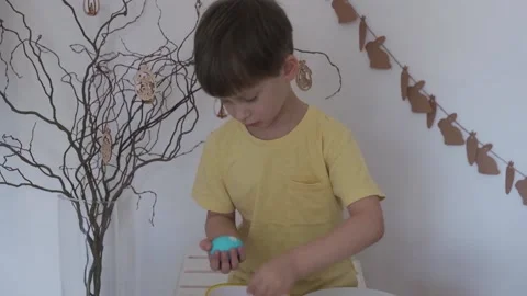 Happy Easter. Little boy peels the Easter egg Stock Footage 147950967