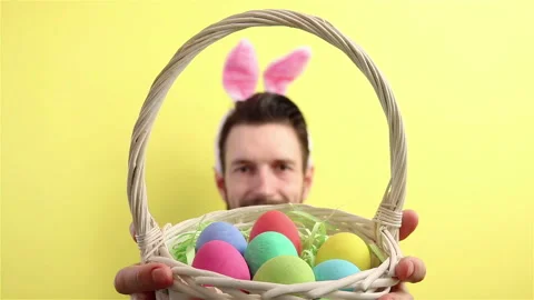 Happy easter  man in bunny ears  gives wicker basket with egg to the camera Stock Footage 148226908