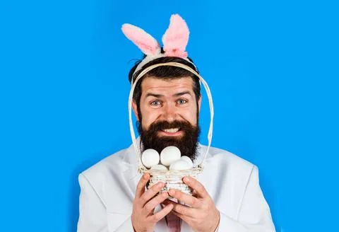 Happy Easter. Man in bunny ears with basket eggs. Funny bunny guy. Stock Photos