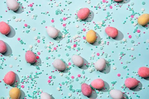 Happy easter minimal background. Scattering of chocolate eggs in sugar glaze and Stock Photos