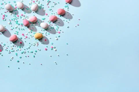 Happy easter minimal background. Scattering of chocolate eggs in sugar glaze and Stock Photos