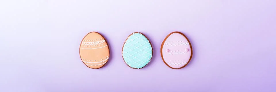 Happy Easter minimalistic background. Multicolored pastel easter eggs cookies on Stock Photos