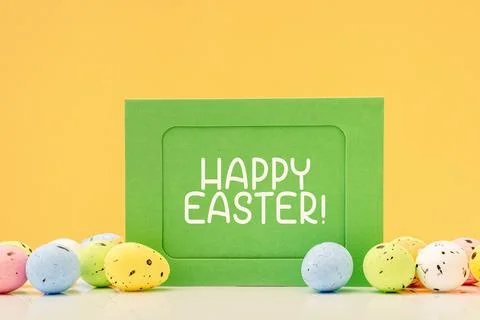 Happy Easter mockup card with eggs on yellow Stock Photos