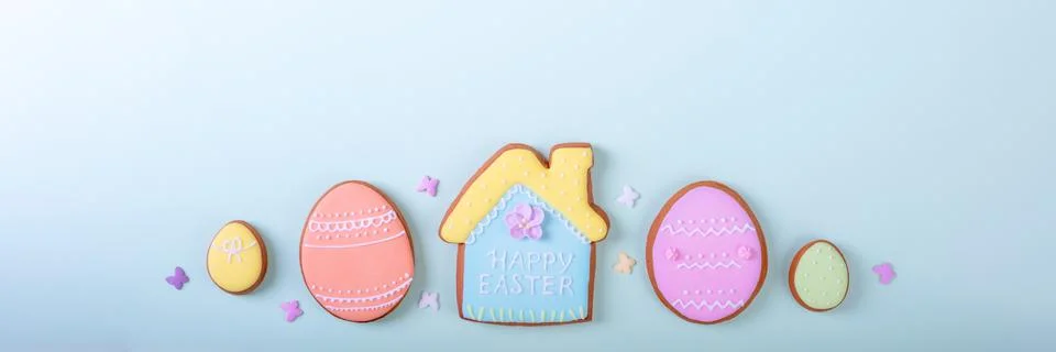 Happy Easter. Multi Colored banner pastel easter cookies on a blue background. Stock Photos