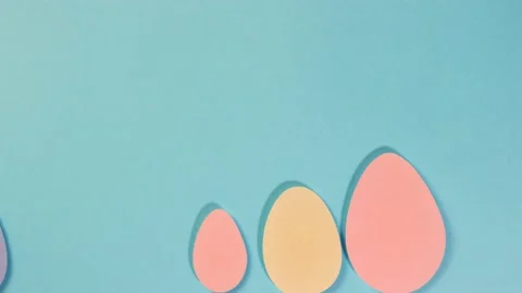 Happy Easter. Multi-colored eggs move on a blue background. Two white rabbit Video stock 170150319