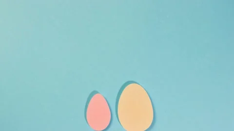 Happy Easter. Multi-colored eggs move on a blue background. Two white rabbit Video stock 170352284