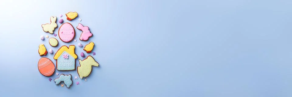 Happy Easter. Multicolored pastel easter cookies on a blue background. Stock Photos