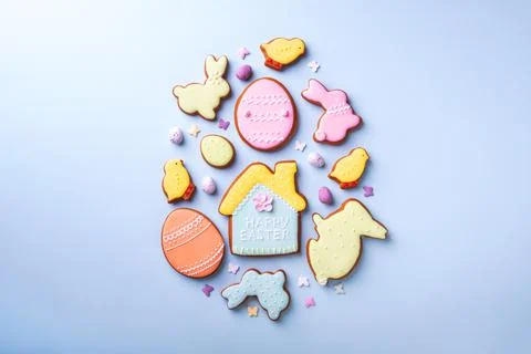 Happy Easter. Multicolored pastel easter cookies on a blue background. Stock Photos