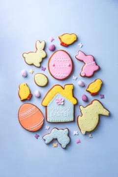 Happy Easter. Multicolored pastel easter cookies on a blue background. Stock Photos