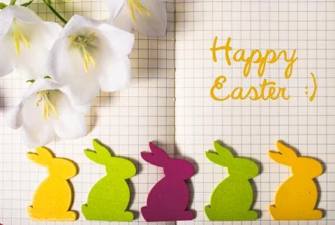 Happy Easter. note book close-up with spring flowers, colorful easter rabbits Stock Photos