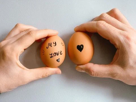 Happy Easter or st valentines morning before breakfast. Young couple holding Stock-Fotos